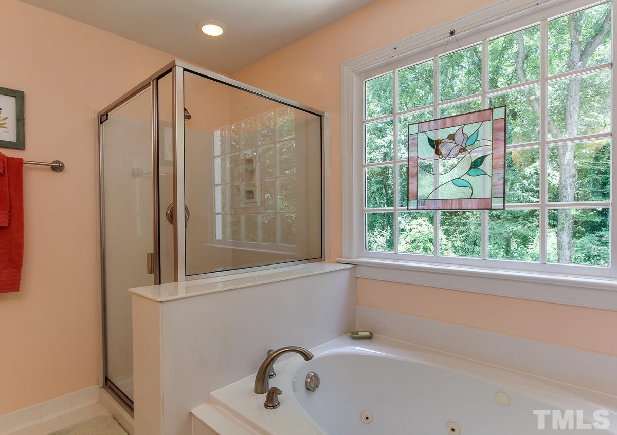 4601 Wee Burn Trail Raleigh, NC 27612 - Photo 14 of 25 a bathroom with a sink and a large window