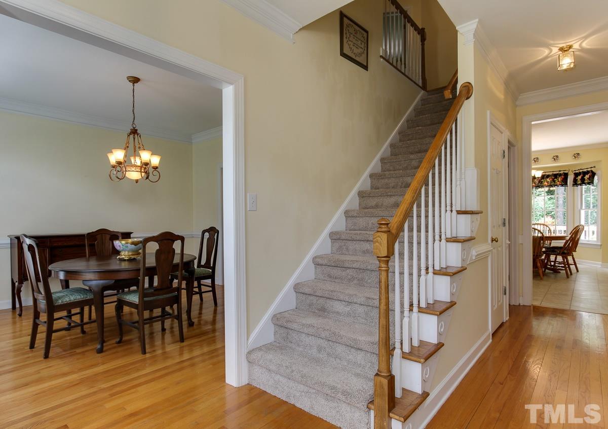 4601 Wee Burn Trail Raleigh, NC 27612 - Photo 3 of 25 a view of a dining room with furniture and wooden floor