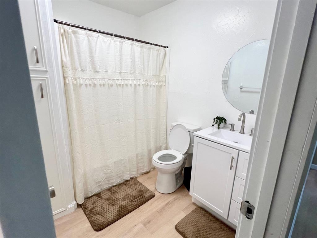 38 Valley View Circle Denison, TX 75021 - Photo 11 of 15 a bathroom with a toilet and a mirror