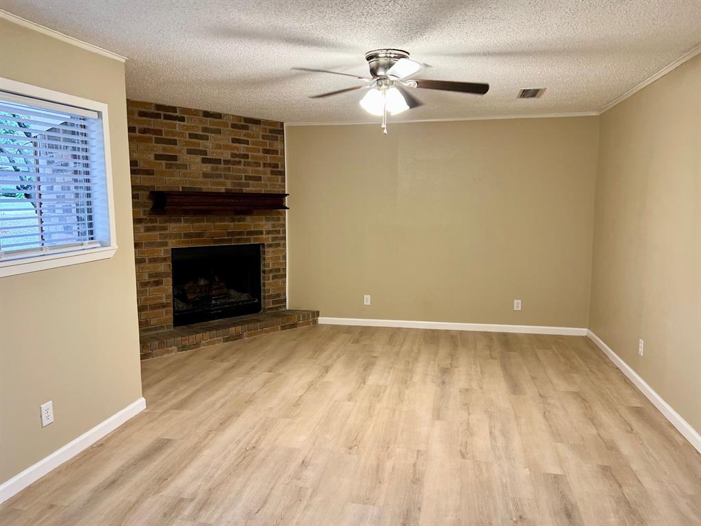 38 Valley View Circle Denison, TX 75021 - Photo 4 of 15 wooden floor fireplace and natural light in room