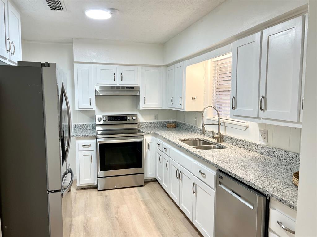38 Valley View Circle Denison, TX 75021 - Photo 5 of 15 a kitchen with granite countertop a sink stainless steel appliances and window