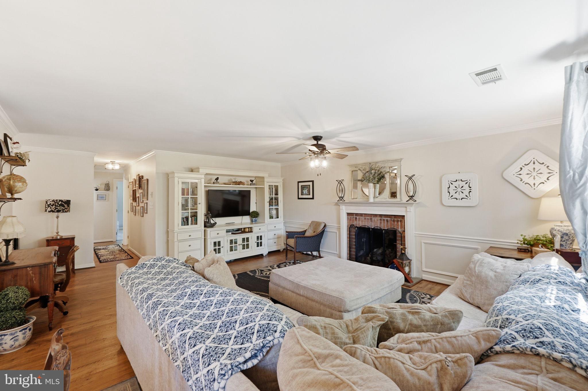 19608 Gott Street Poolesville, MD 20837 - Photo 21 of 43 a living room with furniture a fireplace and a flat screen tv