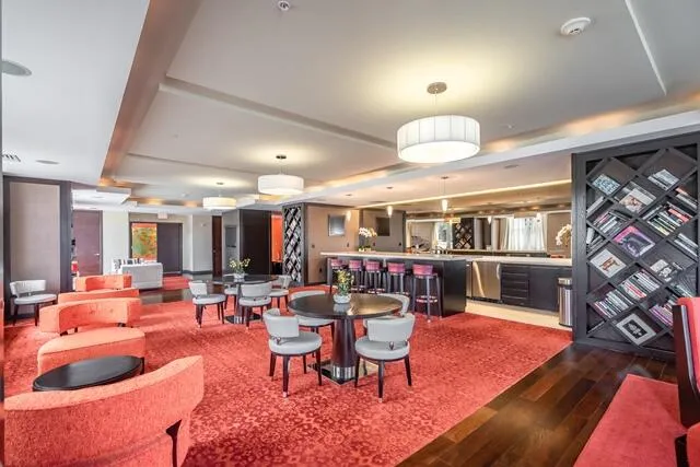 a living room with furniture a chandelier and a rug