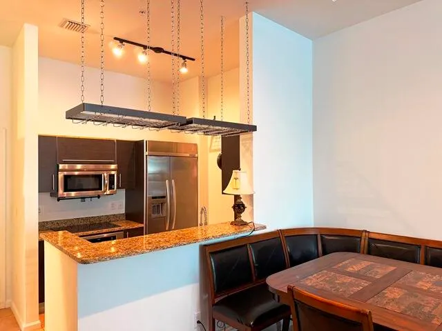 a living room with a table and chairs