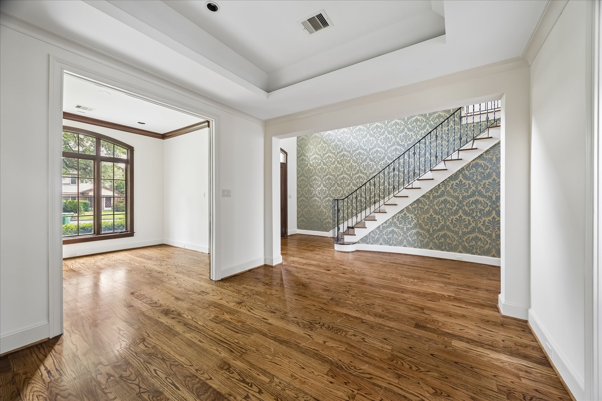 2246 Branard Street Houston, TX 77098 - Photo 5 of 40 Thoughtfully connected living spaces create an effortless flow between the dining room, foyer, and adjacent den.