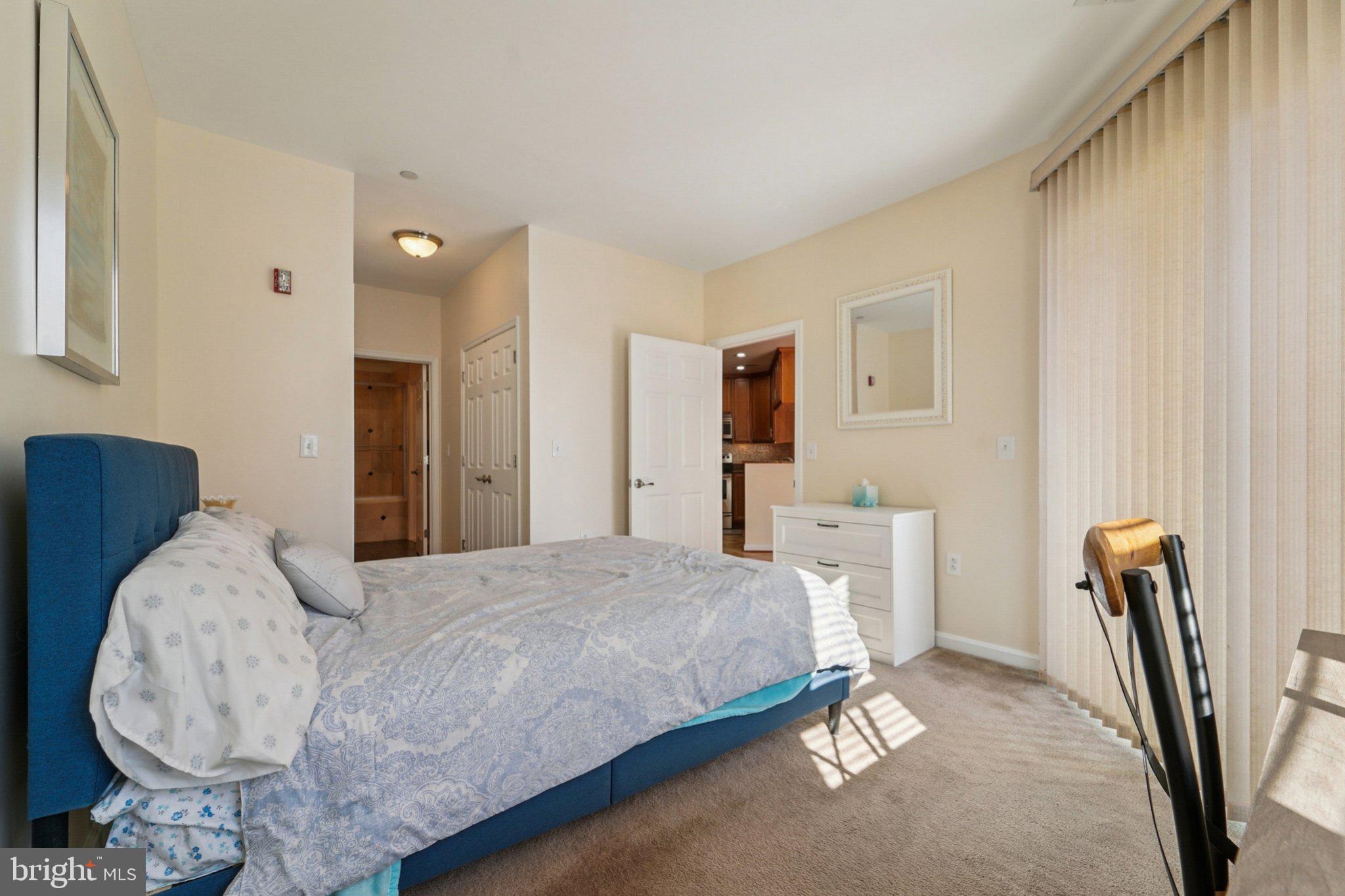 23 Pierside Drive, Unit 118 Baltimore, MD 21230 - Photo 19 of 32 a bedroom with a bed a couch and dresser