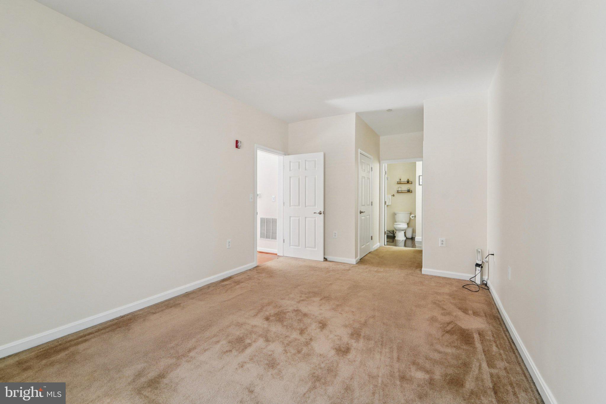 23 Pierside Drive, Unit 118 Baltimore, MD 21230 - Photo 21 of 32 a view of a big room with closet and wooden floor