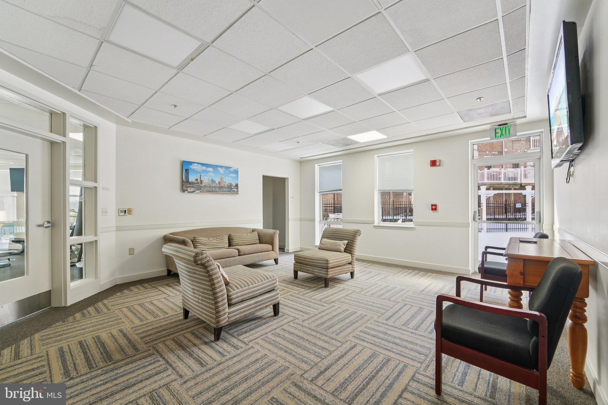 23 Pierside Drive, Unit 118 Baltimore, MD 21230 - Photo 26 of 32 a living room with furniture and a flat screen tv