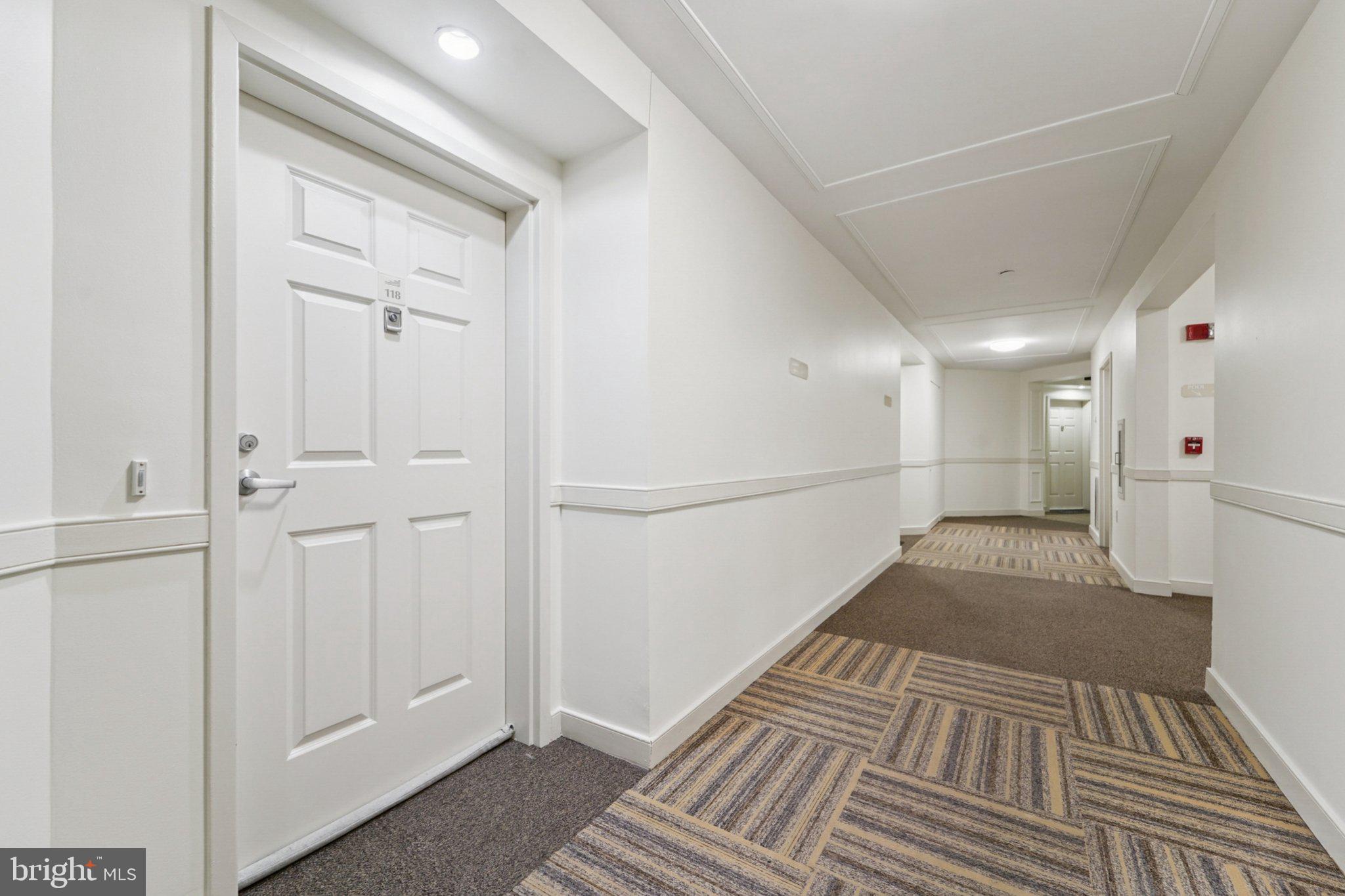 23 Pierside Drive, Unit 118 Baltimore, MD 21230 - Photo 5 of 32 a view of a hallway with wooden floor