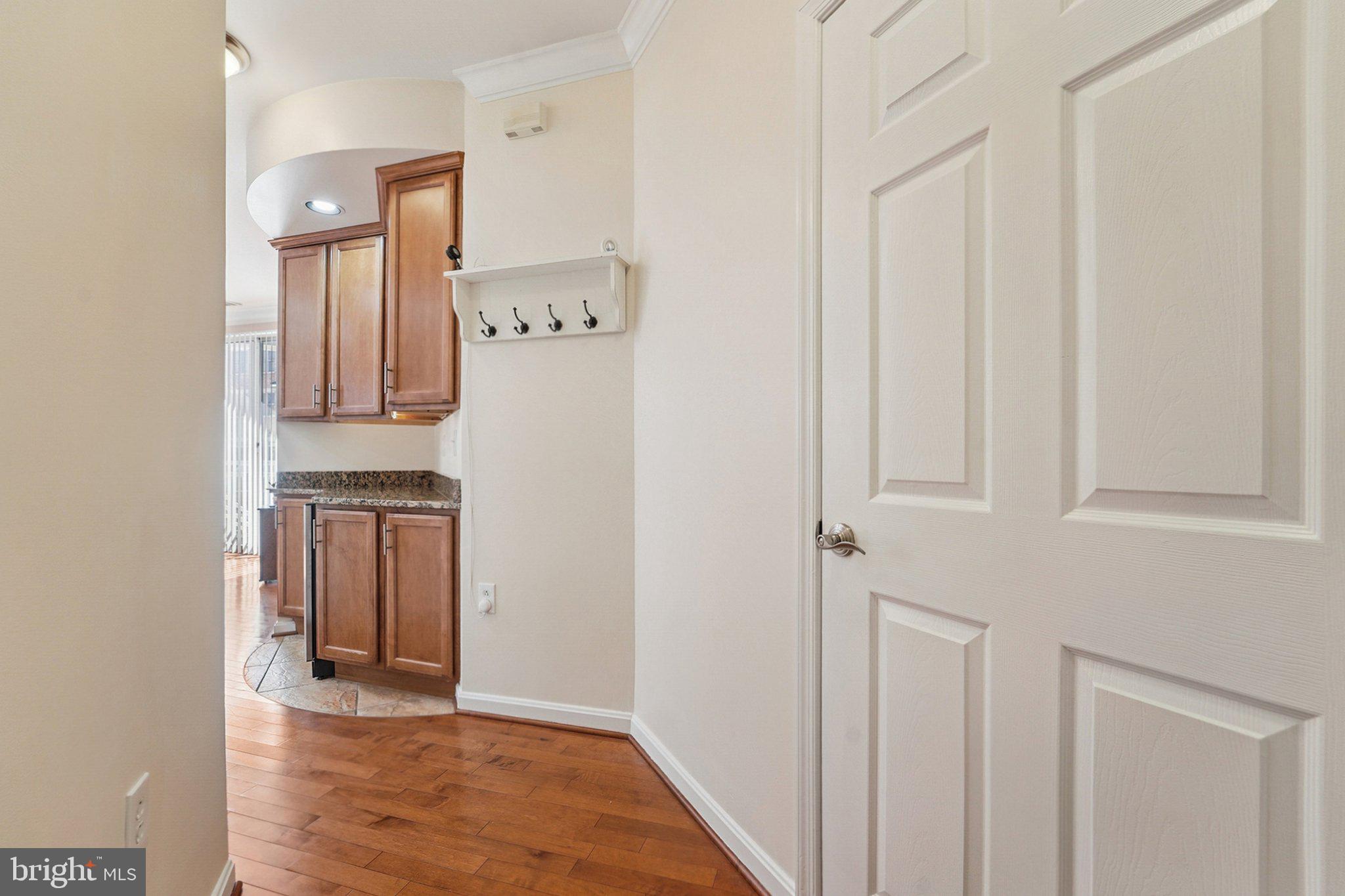 23 Pierside Drive, Unit 118 Baltimore, MD 21230 - Photo 7 of 32 a view of a hallway with wooden floor and cabinets
