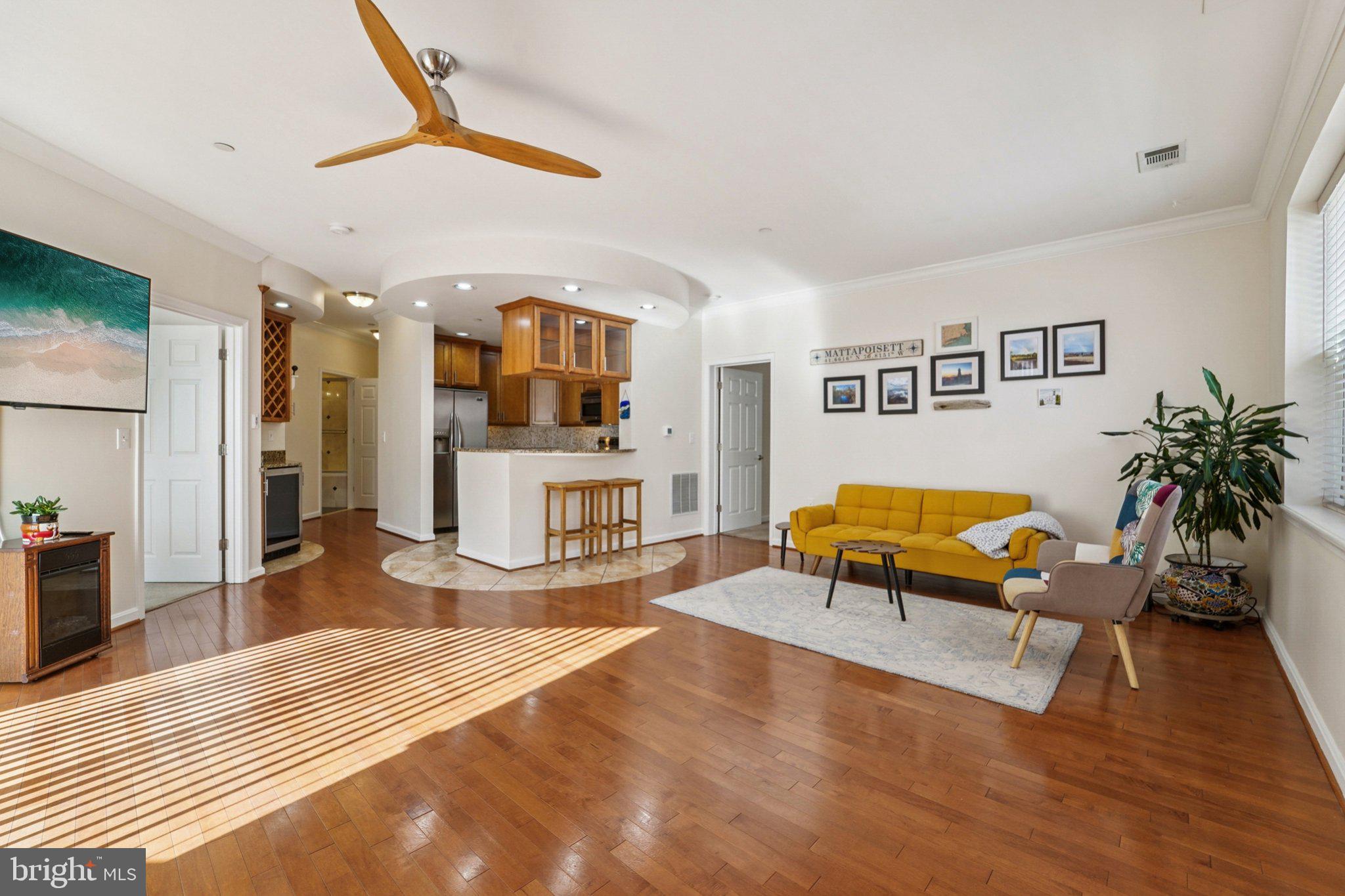 23 Pierside Drive, Unit 118 Baltimore, MD 21230 - Photo 10 of 32 a living room with furniture and a flat screen tv