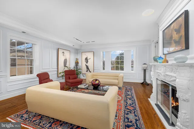 a living room with furniture fireplace and flat screen tv