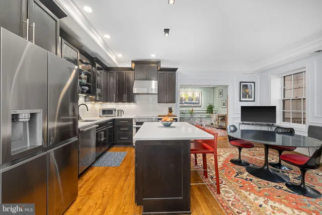a kitchen with counter top space appliances and windows