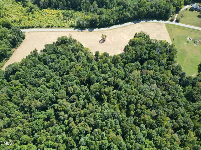 an aerial view of a house with a yard and outdoor seating
