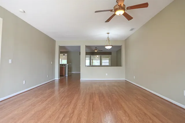 wooden floor in an empty room with a window