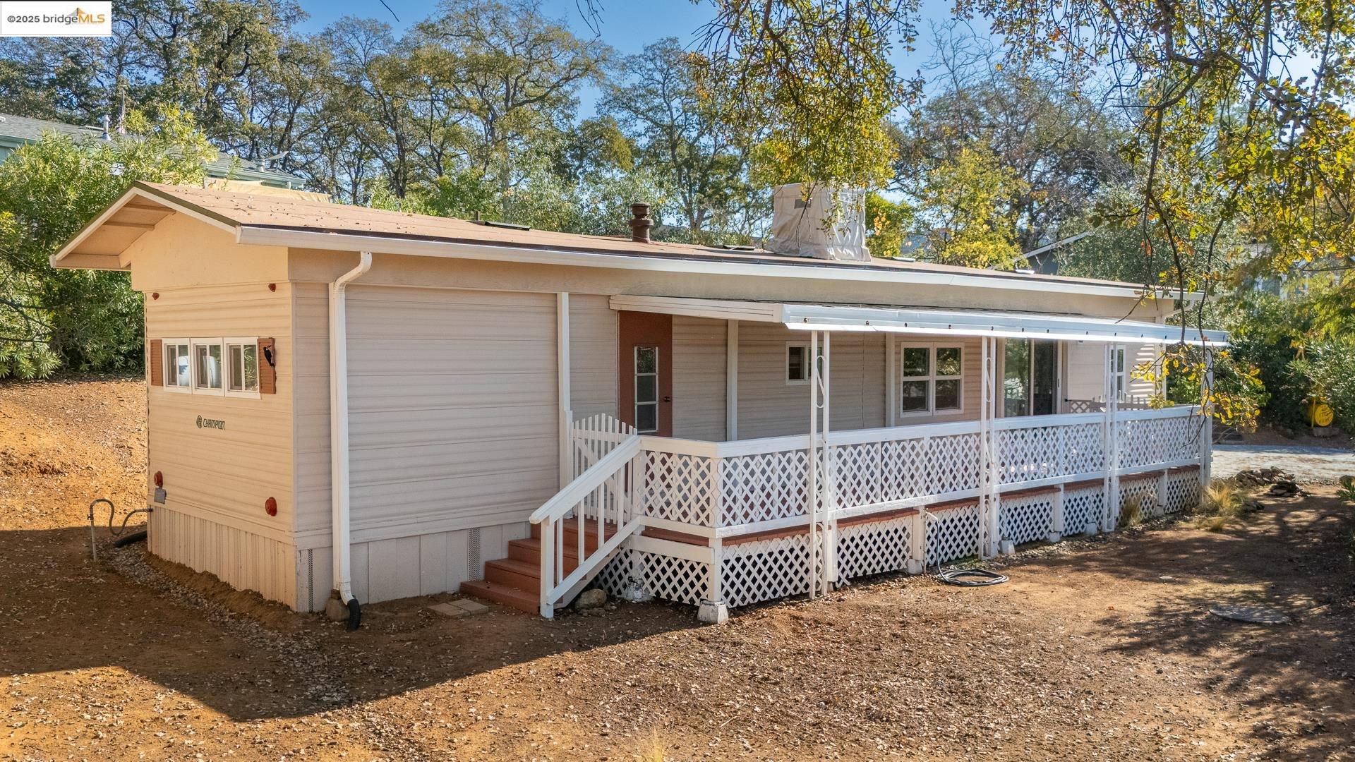 a view of house with a yard and deck