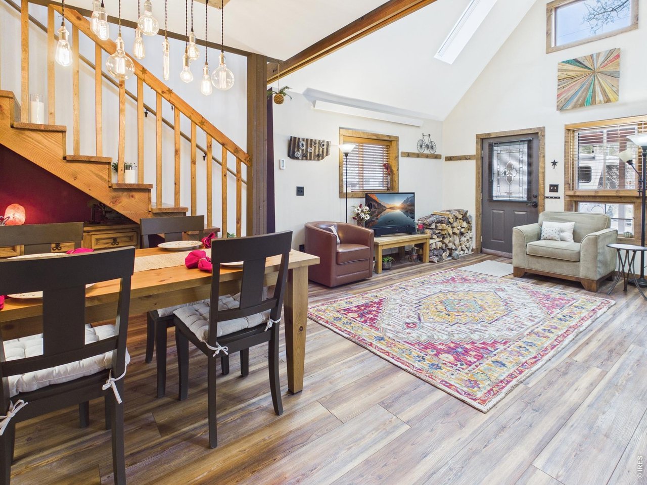 131 West Boulder Street Nederland, CO 80466 - Photo 46 of 46 Open floorplan, wood beams, vaulted ceilings, skylights, transom windows, hanging light fixture.