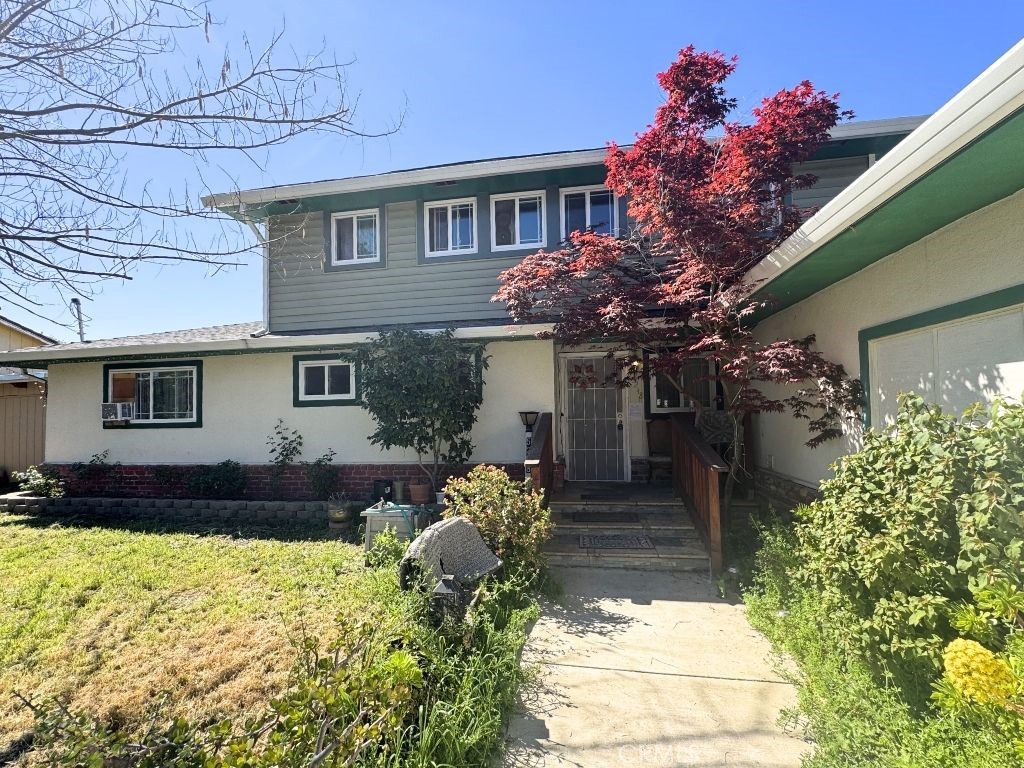 5248 Concord Boulevard Concord, CA 94521 - Photo 2 of 11 a front view of a house with a yard and a garden