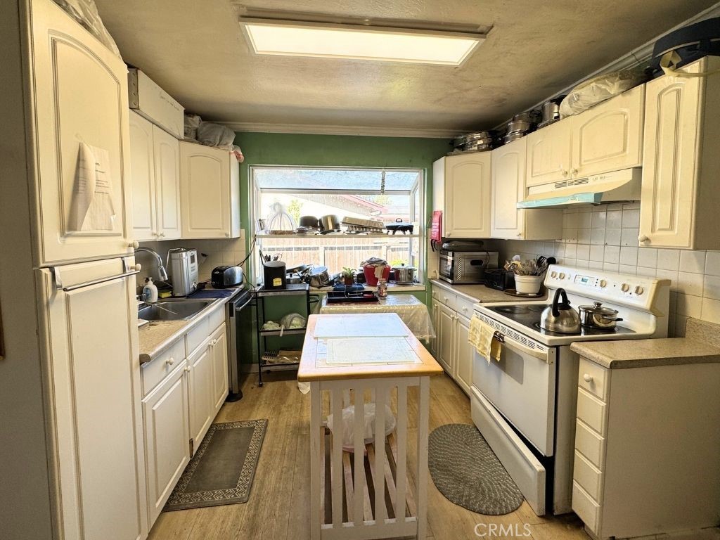 5248 Concord Boulevard Concord, CA 94521 - Photo 6 of 11 a kitchen with stainless steel appliances granite countertop a sink a stove and a refrigerator