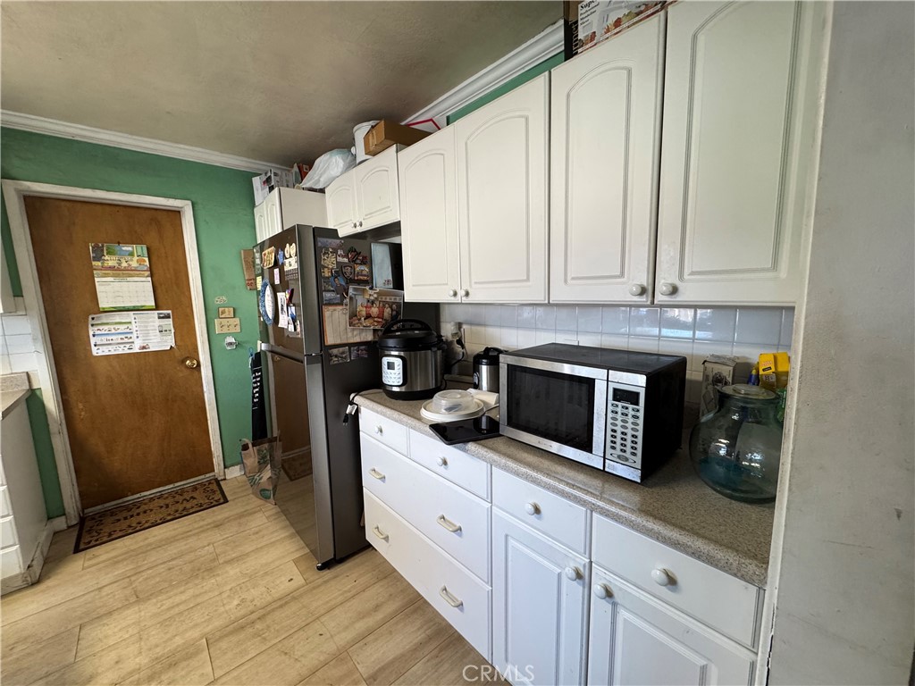 5248 Concord Boulevard Concord, CA 94521 - Photo 7 of 11 a kitchen with stainless steel appliances a refrigerator sink and cabinets