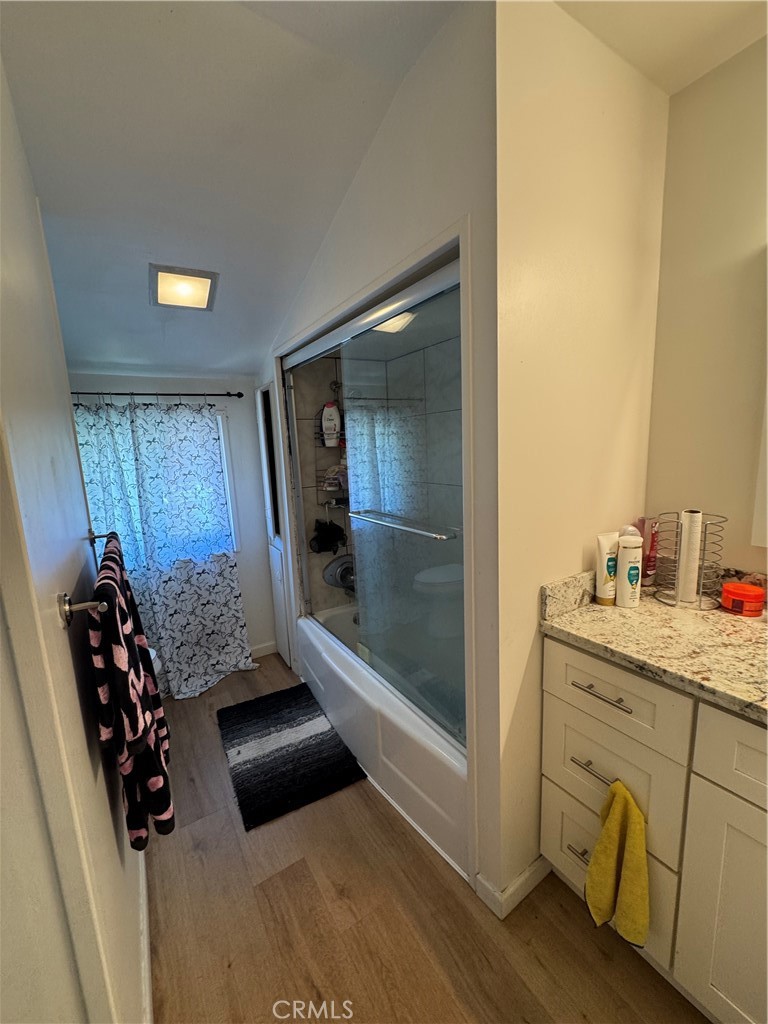 5248 Concord Boulevard Concord, CA 94521 - Photo 9 of 11 a bathroom with a granite countertop sink a mirror and shower