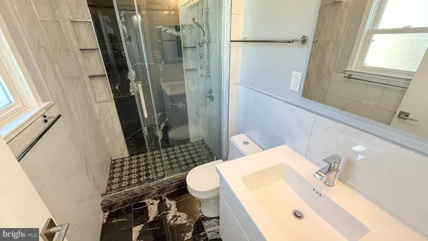 a bathroom with a sink toilet and shower