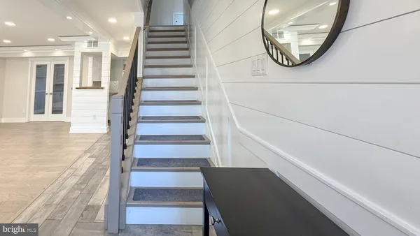 a view of a hallway with wooden floor and entryway