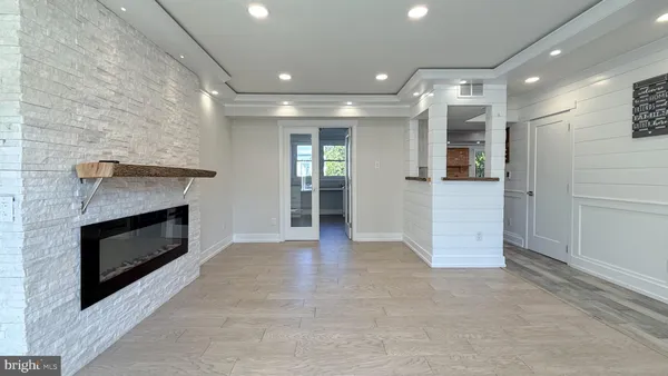 a kitchen with white cabinets and window