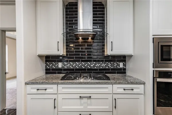 a kitchen with stainless steel appliances granite countertop a refrigerator oven a sink and dishwasher