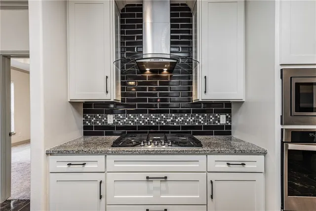 a kitchen with stainless steel appliances granite countertop a refrigerator oven a sink and dishwasher