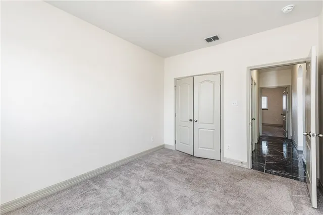 a bathroom with a granite countertop sink toilet and mirror