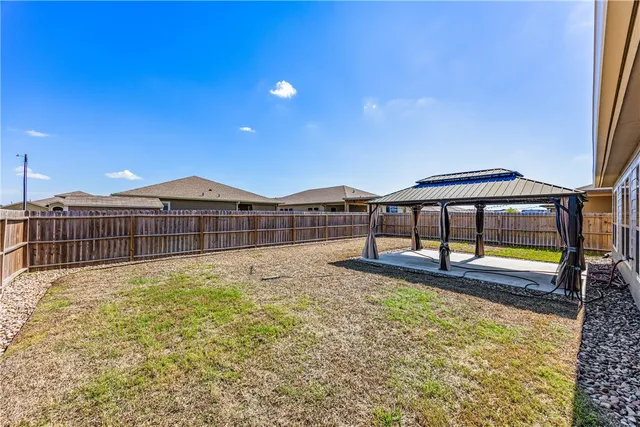 a house view with swimming pool in front of it