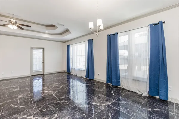 a large kitchen with granite countertop a stove a sink a center island and cabinets