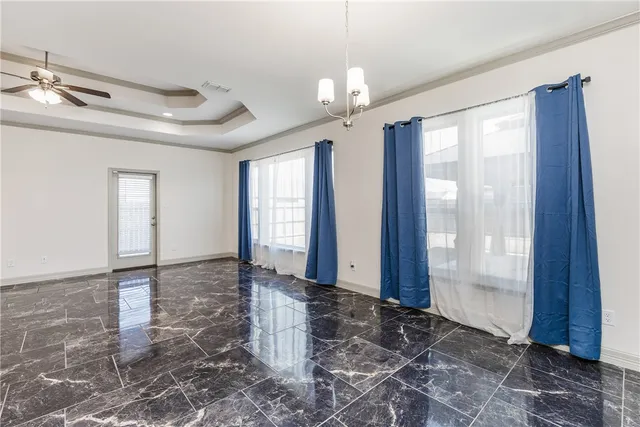 a large kitchen with granite countertop a stove a sink a center island and cabinets