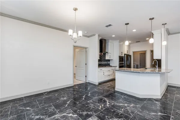 a stove top oven sitting inside of a kitchen