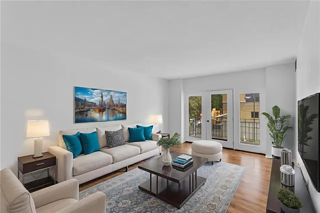 a living room with furniture and a potted plant on table