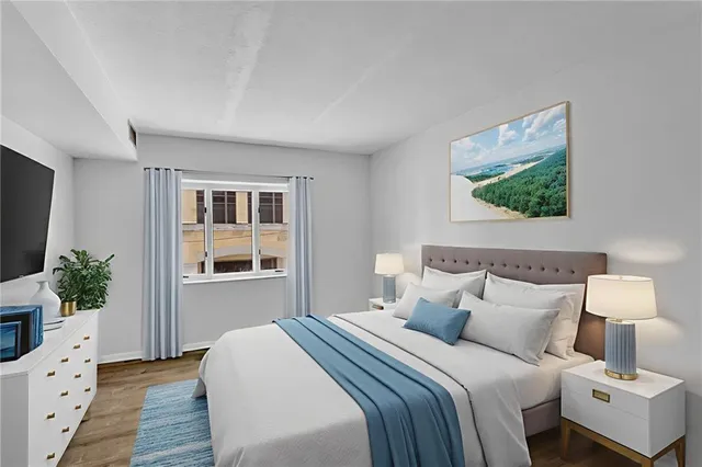 a bedroom with a bed and a flat screen tv