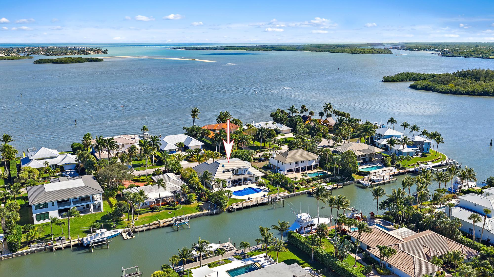 19 Island Road Sewall's Point, FL 34996 - Photo 1 of 50 an aerial view of a house with a lake view