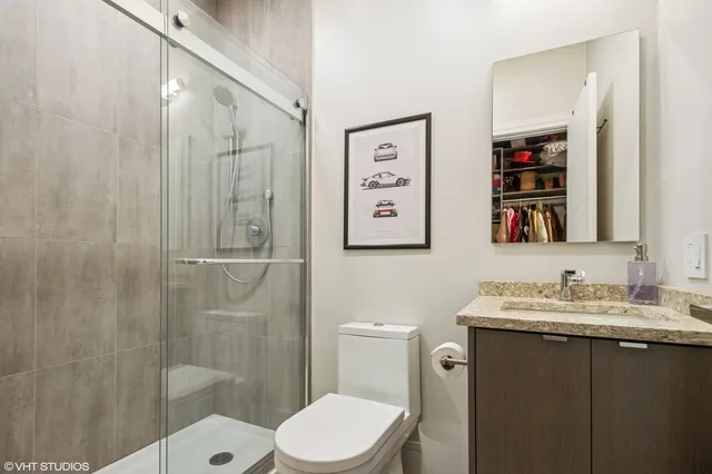 a bathroom with a sink a toilet and shower