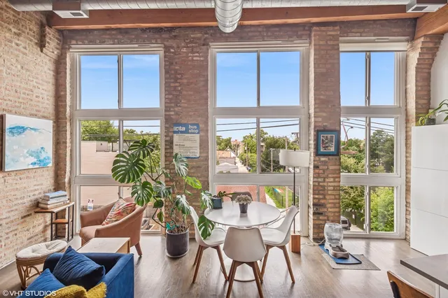 a dining room with furniture window and wooden floor