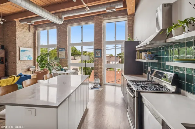 a kitchen with stainless steel appliances granite countertop a sink stove and cabinets