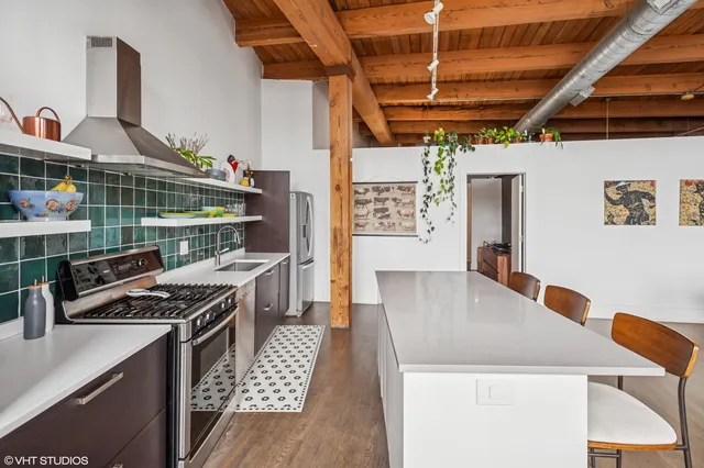 a kitchen with stainless steel appliances granite countertop a stove a sink and a microwave