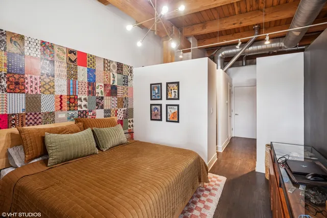 a bedroom with a large bed and a book shelf