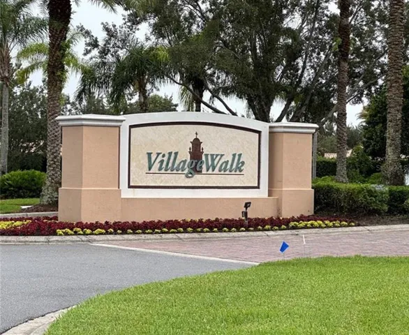 a view of a street with a large tree