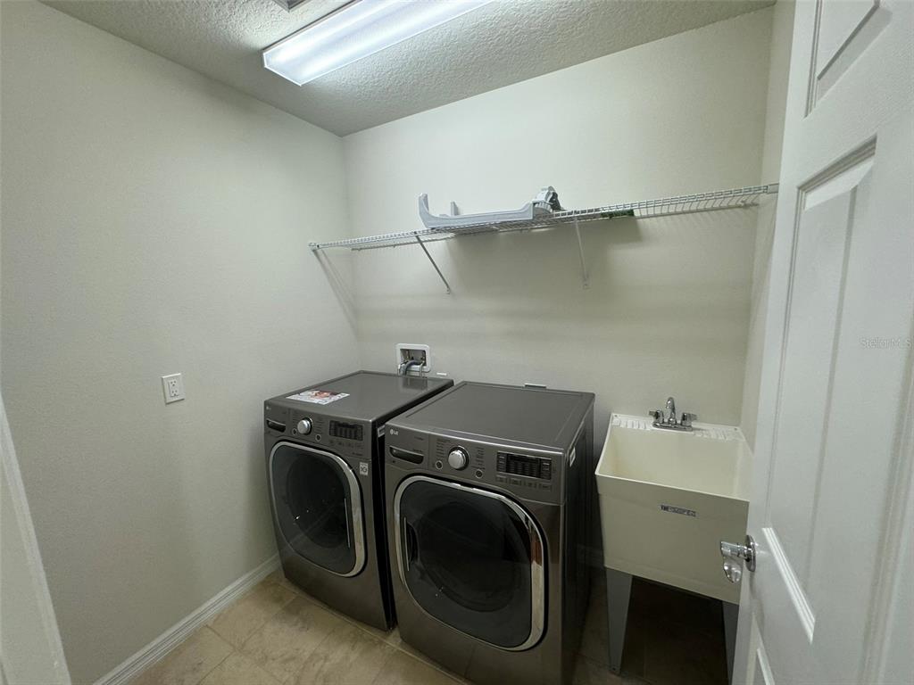 12124 Talitha Lane Orlando, FL 32827 - Photo 25 of 30 a utility room with dryer and washer