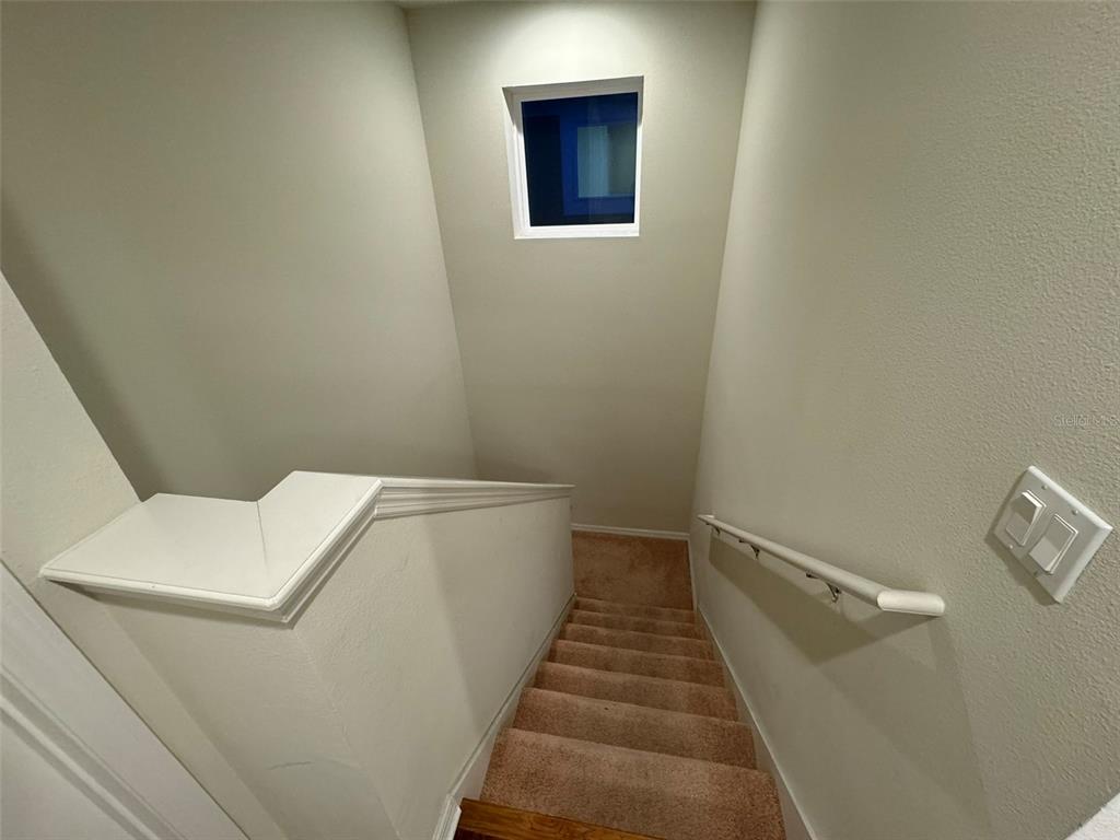 12124 Talitha Lane Orlando, FL 32827 - Photo 27 of 30 a view of a hallway with stairs