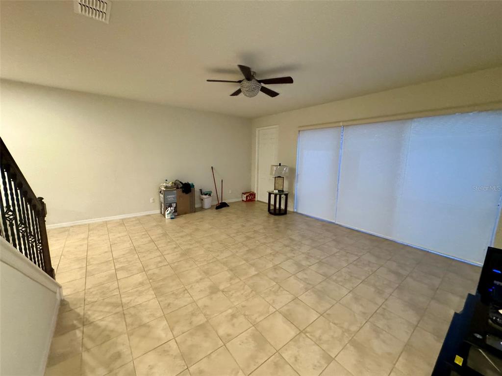 12124 Talitha Lane Orlando, FL 32827 - Photo 4 of 30 a view of a livingroom with a staircase
