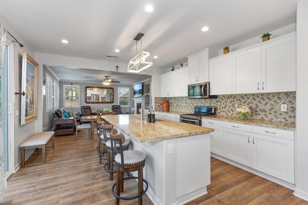 4260 C. Del Vista Oceanside, CA 92057 - Photo 15 of 38 a kitchen with cabinets a sink and chairs in it