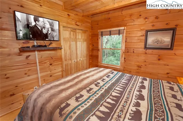 a spacious bathroom with a double vanity sink a mirror and a shower