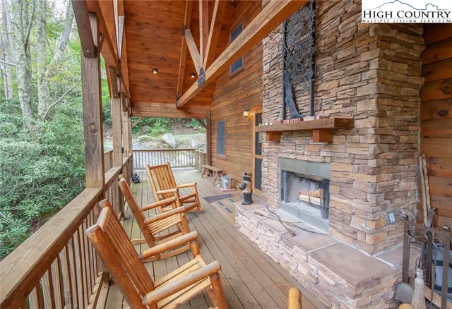 a view of a balcony with chairs and wooden floor